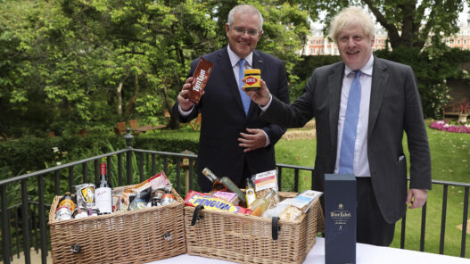 Prime Minister Boris Johnson and Australia’s Prime Minister Scott Morrison pose for a photograph with a hamper full of Australian and British goods in the garden of 10 Downing Street.